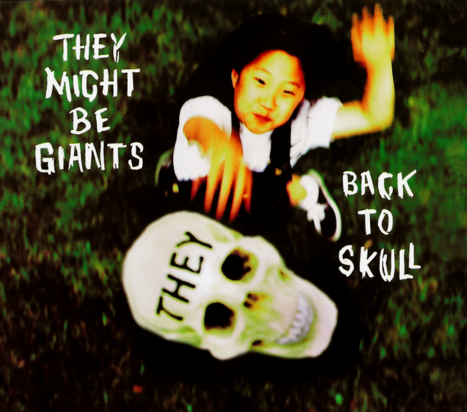 the cover of the EP 'back to skull' by they might be giants, showing a young girl tossing a skull with the word 'they' on the forehead